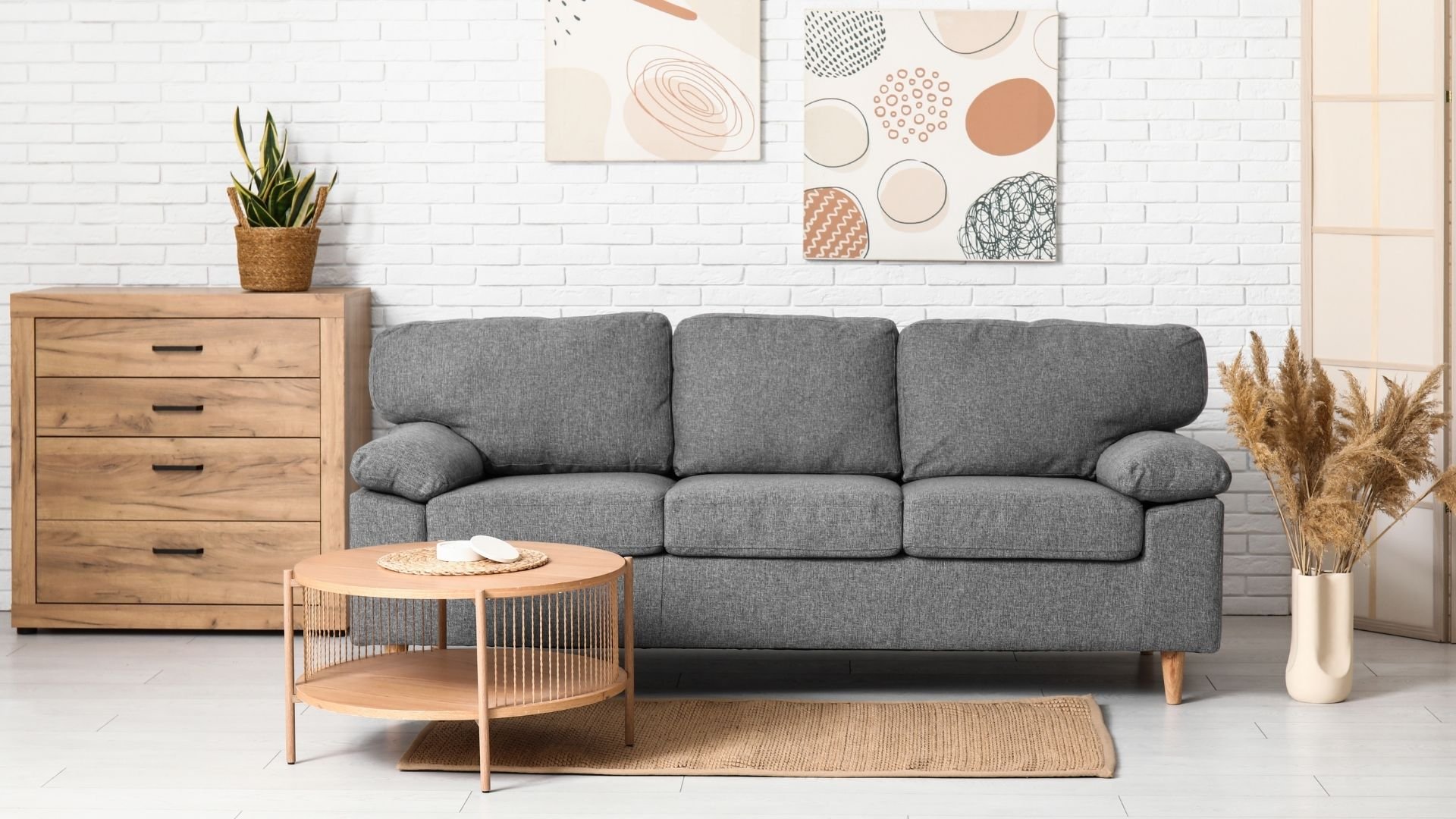 Moving day setup with gray sofa, wooden furniture, and modern decor